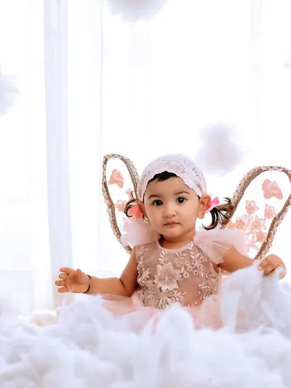 A sweet, curious look from our little angel. The high-key lighting creates a bright and airy feel.