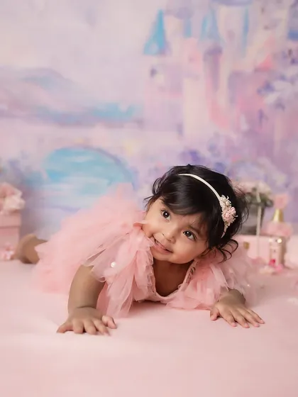 A playful pose on her tummy, showing off her curious expression. Milestone sessions are perfect for capturing these new physical abilities.