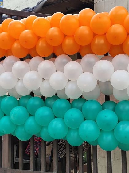 This is a section of a thick, tricolor balloon garland used for decorating a large gate. The dense packing of balloons ensures a full and impactful look from a distance.