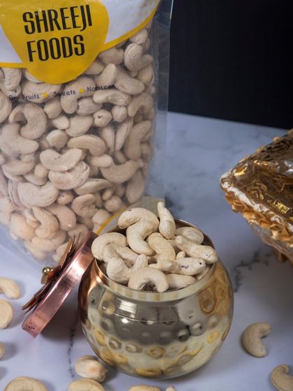 A closer look at my premium cashews. I love how they look in this traditional brass container. They are perfect for gifting or just treating yourself. You can see the fresh pack right behind it.