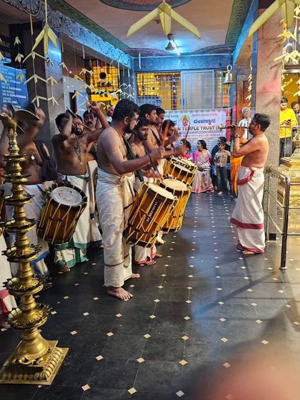 A side view of our ensemble performing at the Ulsoor Ayyappan Temple, showing the disciplined line of Chenda and Ilathalam players.