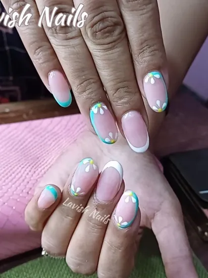 A cute and creative set with multi-colored French tips and small, hand-painted daisies.