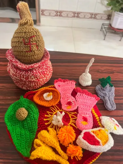 My custom crochet pooja thali set includes all the essentials for your prayers, like a kalash, diya, flowers, and leaves, all handcrafted with colorful yarn.