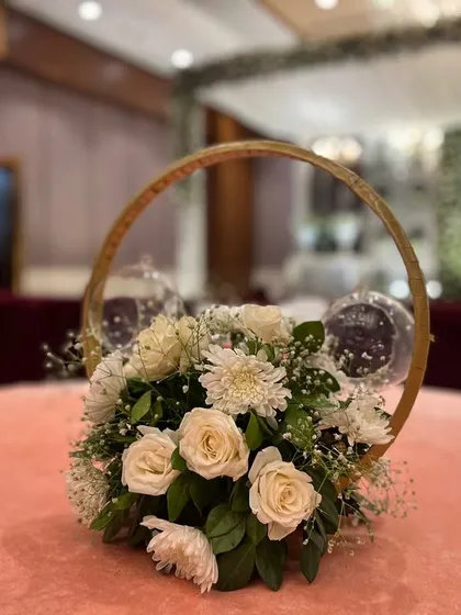 A similar centerpiece design with white roses, used for the elegant Walima reception at Crowne Plaza.