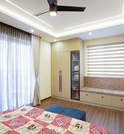 This bedroom at Pashmina Waterfront focuses on timeless elements. A built-in window seat offers a cozy spot with storage, and the muted palette is designed to age beautifully.
