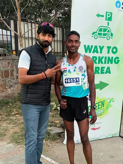 Posing with one of my athletes at the SBI Green Marathon. His dedication in training paid off with a strong performance.