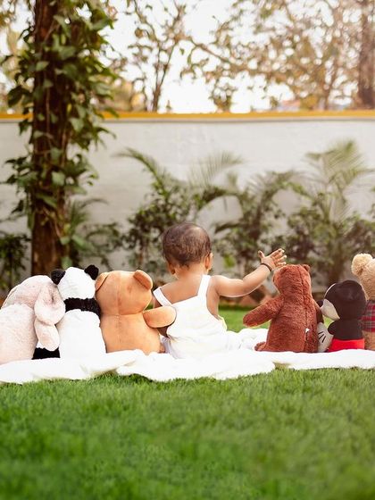 A baby's view of his friends. This creative shot from behind shows the world from his perspective during an outdoor picnic.