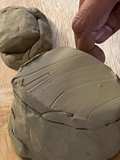 A close-up of clay being prepared for a project. The texture and malleability of the material are part of what makes working with clay such a satisfying and grounding experience.