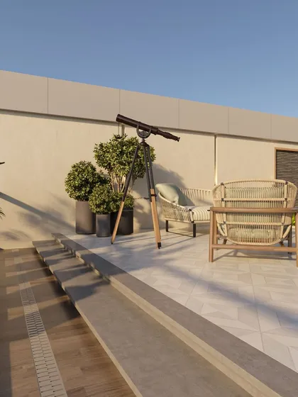 An open-air seating nook on the upper level of the terrace, complete with a telescope for stargazing. The choice of natural rattan furniture and potted topiary trees creates a relaxed and slightly whimsical atmosphere.