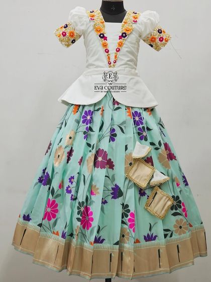 A beautiful floral lehenga set with a white peplum blouse and a pastel blue skirt.
