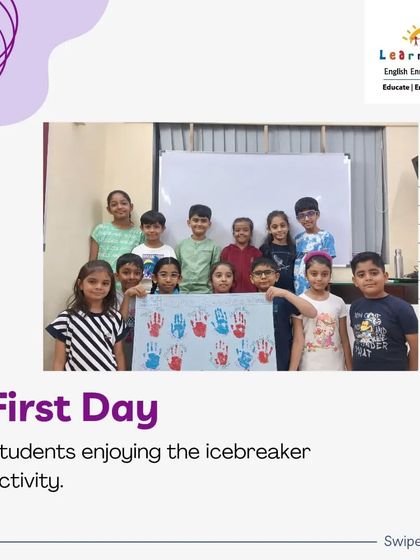A group of students proudly showing off their completed handprint poster from our first-day icebreaker. This collaborative art project represents the start of their journey together as a class.