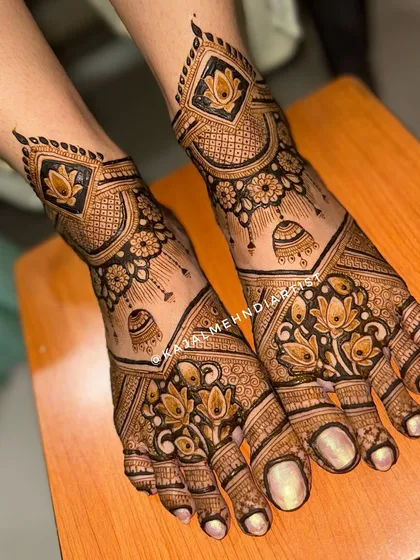 An angled view of the bridal leg design with jhumkas and lotuses.