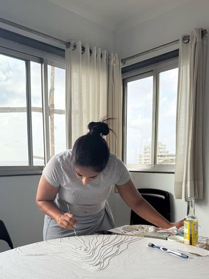 A wider view of my workspace as I meticulously craft the texture of the artwork.