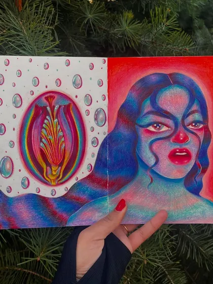 Holding the sketchbook open to the surreal portrait spread.