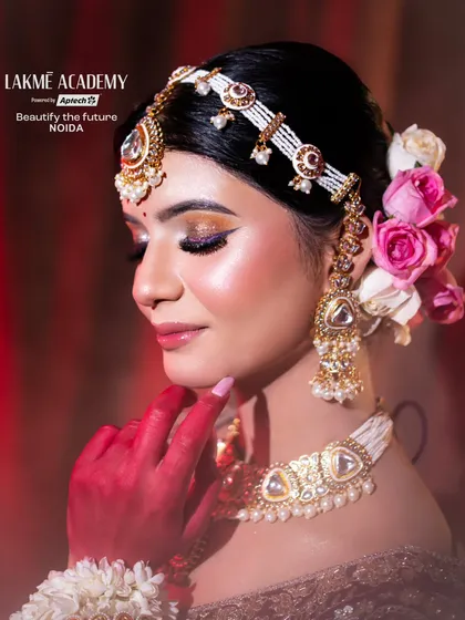 A close-up on the side profile of a contemporary bride. This view emphasizes the flawless eye makeup, the intricate earring design, and the elegant hair styling taught in our courses.