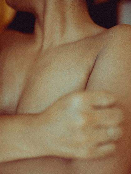 Another abstract and intimate detail shot. The soft focus and warm tones create a sensual and artistic image that focuses on the human form.