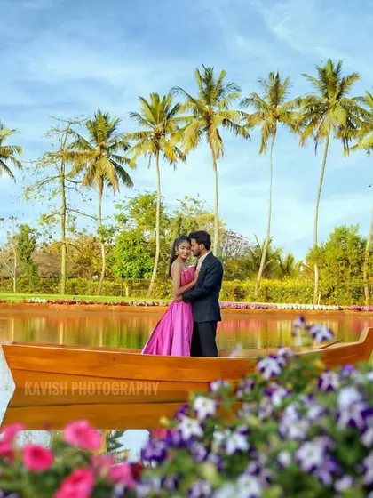 An intimate embrace on a boat surrounded by calm waters and flowers. This pre-wedding portrait is full of warmth and affection.