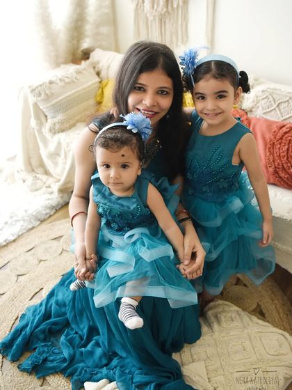 A "Mumma and me" session with two beautiful daughters. The coordinated teal dresses and the genuine smiles make this a heartwarming portrait of a mother's love.