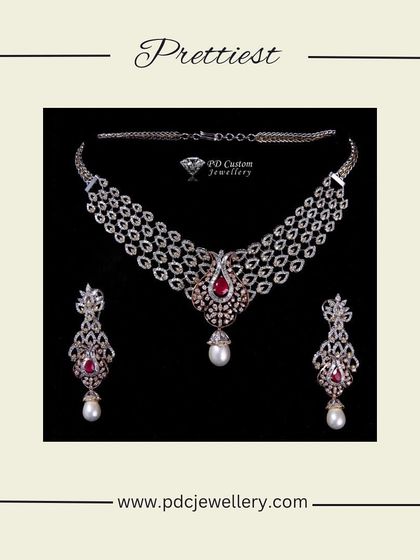This diamond necklace set is designed with a touch of vintage charm. It features three rows of diamonds accented with ruby and pearl drops, all set in 14kt hallmarked gold.