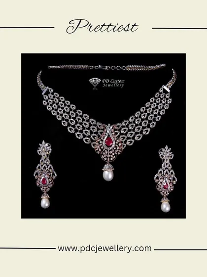 A gorgeous diamond necklace set featuring a three-tiered design with ruby and pearl drops. This piece combines the sparkle of diamonds with a pop of color, making it a beautiful choice for any celebration.