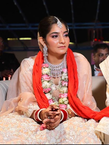A candid shot of the bride during her wedding ceremony, looking on with a thoughtful expression.
