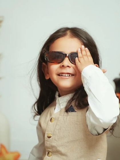 A cool and confident pose during a pre-mundan shoot. We let your child's personality shine through with fun props like sunglasses.