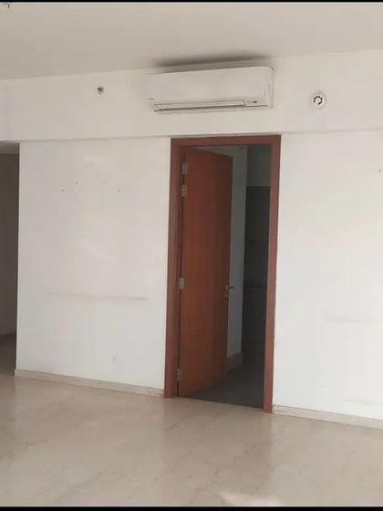 The starting point for this drawing room was a plain, empty space with a single door, offering little character.