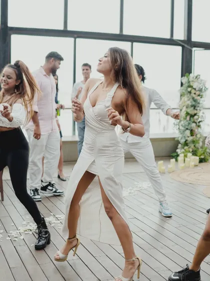 Pure energy and happiness radiating from the bride-to-be during her surprise proposal performance. This candid shot is all about capturing the peak emotion of the celebration.