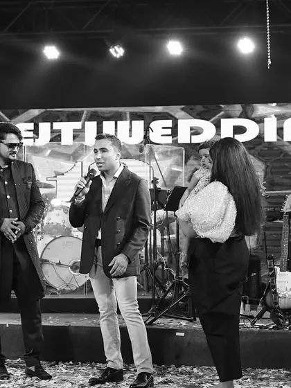 On stage with guests during a fun interactive segment at a Goa wedding. These unscripted moments often become the most memorable parts of the night.