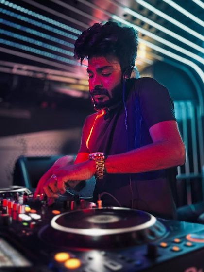 A cool, moody shot of me at the decks at Helium, Pune, under blue and red lights.
