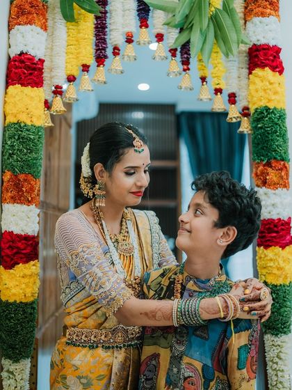 This look celebrates family and tradition. My client Archana's son shines in a custom-made, hand-painted Pen Kalamkari kurta, a piece of wearable art that beautifully complements his mother's traditional saree.