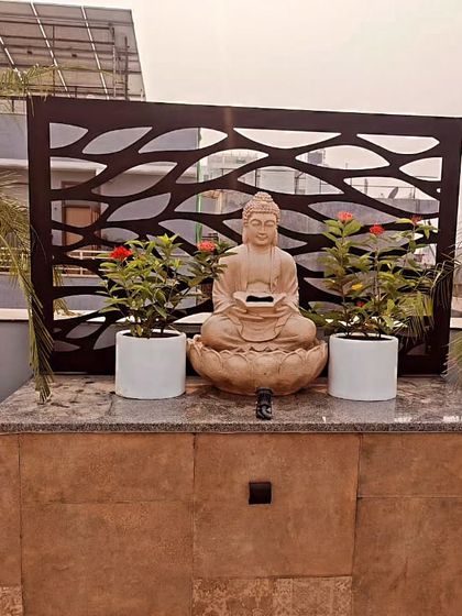 The same Buddha feature during the day, set against a laser-cut metal screen. The design is beautiful both day and night.