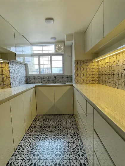 A full view of our completed kitchen makeover. The combination of glossy white cabinets, under-cabinet lighting, and geometric tiles creates a space that is bright, functional, and easy to maintain.