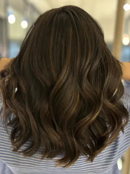 A caramel mocha balayage blend on a textured long bob. This cut and color combination is sophisticated, modern, and full of beautiful dimension.