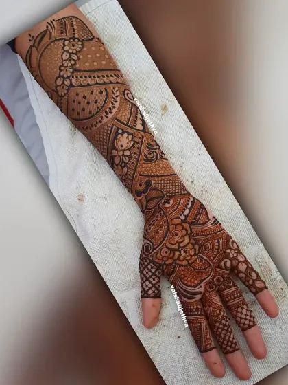 A full-arm "Tapasavi" or ascetic-themed design. This is a unique and artistic choice for those looking for something different from typical bridal patterns.