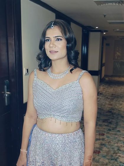 A client ready for an event with her hair styled in retro-inspired waves. This short hairstyle is chic and modern, perfect for a cocktail party.