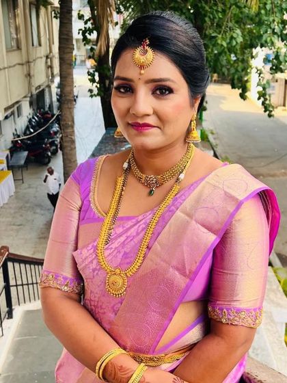 A simple yet elegant look for a client attending a wedding. The makeup focuses on clean skin and defined eyes, complementing her lavender silk saree.