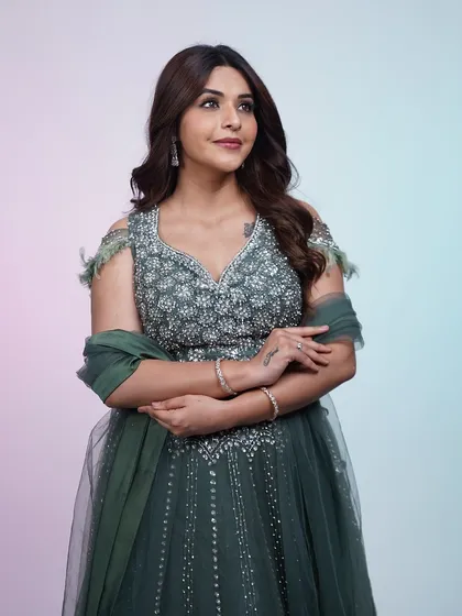 A full-length shot of the dark green lehenga, perfect for an evening event. The silver embroidery sparkles beautifully under the lights.