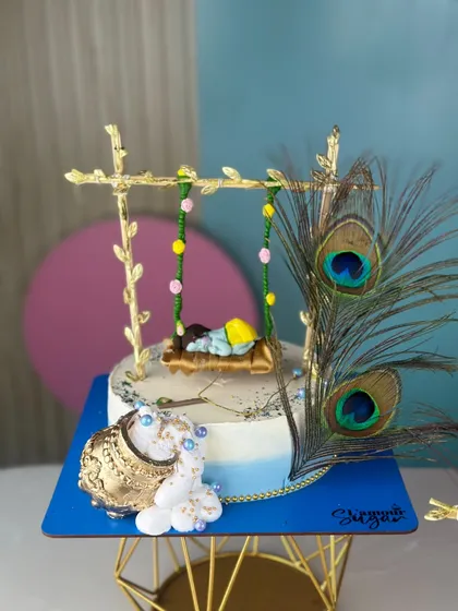 We love bringing festive themes to life with our edible art. This handcrafted Janmashtami cake setup, with its intricate details like the golden swing and peacock feathers, is a sweet offering designed to add a divine touch to your pooja or celebration.