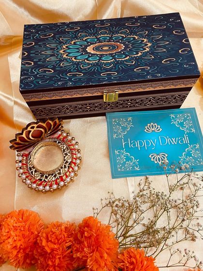 The ornate lid of a dark blue wooden box, perfect for premium Diwali gifting.
