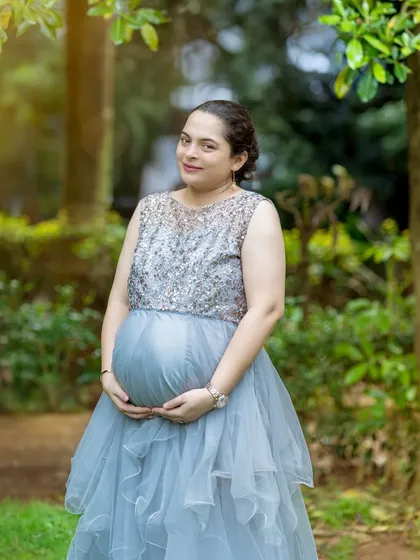 A solo shot of the mother wearing a stunning sequined and ruffled grey gown. This highlights one of the elegant options available for rent from my client closet.