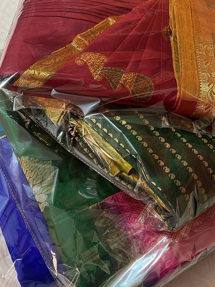 A stack of packed sarees, ready for delivery. Customer satisfaction is my top priority.