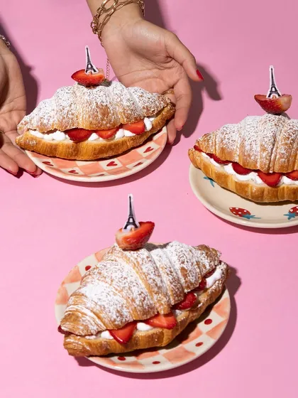 Celebrating National Croissant Day with my signature strawberry and mascarpone cream croissants, each topped with a mini Eiffel Tower pick.