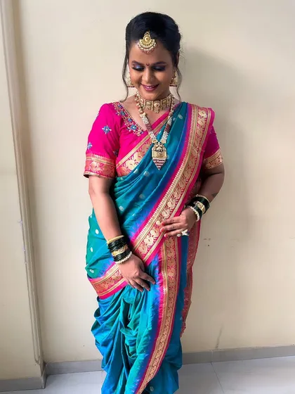A full-length shot showing the beautiful drape of the nauvari saree. I ensure the draping is perfect, or as we say, 'chapoon chopoon nesleli nauvari'.