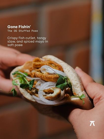 The OG Stuffed Poee, 'Gone Fishin'. A crispy fish cutlet with tangy slaw and spiced mayo tucked into a soft, airy poee bread, a highlight from our pop-up with Klaa Kitchen.