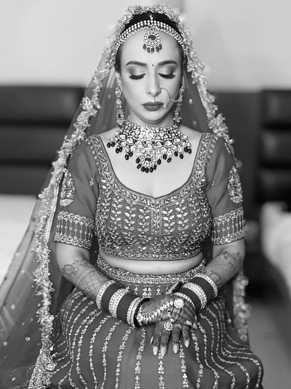 A black and white portrait that captures the serene and timeless beauty of a bride. It highlights the structure and artistry of the makeup beyond the colors.