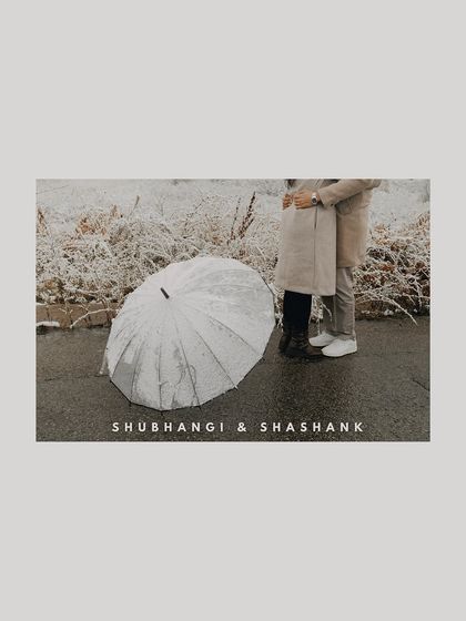 A minimalist and artistic pre-wedding shot in the snow, focusing on the couple's embrace and the texture of their surroundings in Kazakhstan.