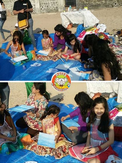 A group of young artists enjoying a sunny day of painting on the beach. It's a perfect blend of creativity and enjoying the outdoors.