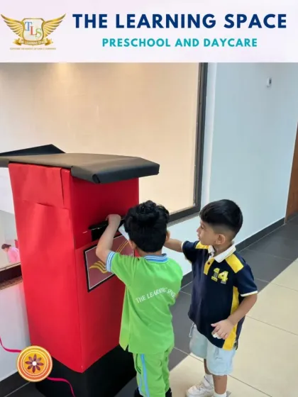 Two boys posting their handmade rakhis. This activity combines the cultural lesson of Raksha Bandhan with a practical life skill, making the experience more memorable.