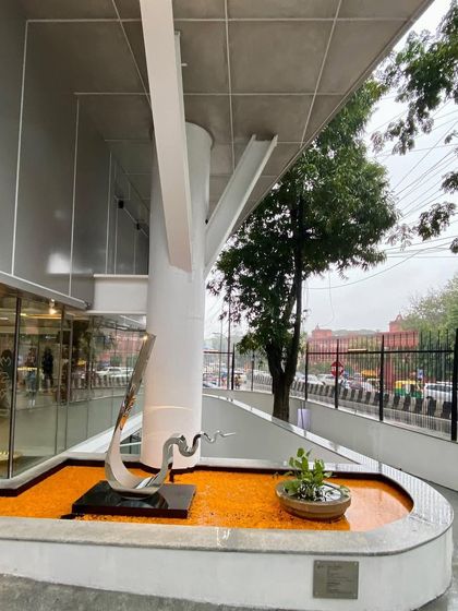 Another view of the entrance water feature at MAP, showing the relationship between the sculpture, the tree-like column, and the street.